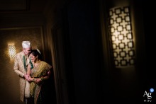 A playful and romantic wedding couple is captured in a creative portrait at an elevator in St. Louis Frontenac