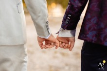 A Captivating Wedding Snapshot: Grand Hotel Dino Delight in Italy as Suited Couple Sweetly Share Pinky Promise A wedding day picture at Grand Hotel Dino in Italy. The couple, dressed in suits, holds pinky fingers in a sweet gesture.