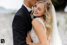 Radiant Love: Embracing Eternal Joy at Villa Volpi in Ghiffa, Italy A bride and groom embrace at Villa Volpi in Ghiffa, Italy. The bride's radiant smile exudes pure joy on their wedding day.