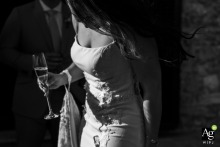 Bride's Dreamy Stroll at Belpoggio Su Todi, Umbria, Italy A walking detail shot of the bride at Belpoggio Su Todi, Todi, Umbria, Italy. She holds her glass, and her dress train loop is draped over her wrist.