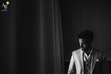Groom's Portrait Near Milagres Hotel Window on Wedding Day Groom's portrait before Milagres hotel window, wedding day anticipation, soft natural light illuminates his face
