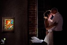 Outside Castle Kerckenbosch, the couple stands together next to a whimsical window, the historic stone and playful architecture offering a distinctively charming backdrop.