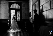 Couple standing in the grand entrance hall of Château Coty, Tarn et Garonne, France.