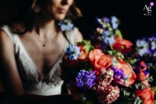 A soft portrait of the bride at Chateau de Mazieres, with a vibrant, colorful bouquet in sharp focus.