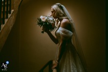 Profile shot of the bride at Château Coty, Tarn et Garonne, France, smelling her bouquet just before the ceremony.