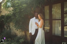 A couple embracing under trees near a building at their home in Auch, Gers, France.
