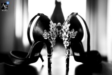 Elegant black and white shot of luxury wedding shoes, artfully arranged in a Canmore hotel room.