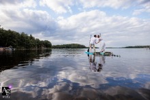 In Duluth, MN, an artistic image captures the wedding couple together on a paddleboard floating peacefully on the lake.