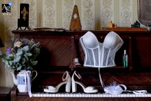 A delicate detail of the bride's intricate wedding apparel, captured artistically in Largentiere, France, focuses on the elegance.