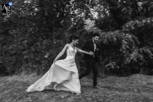Domaine de Parçay — The couple shares a romantic walk during their photo session, captured in black and white with a vintage feel and a sense of urgency, creating a timeless wedding portrait.