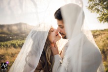 Romantic Sunset Veil Portrait Of Bride And Groom At Lyon Rhone Reception Venue Lyon, Rhône — At sunset, the bride and groom face each other in a very intimate session beneath the bride’s veil, creating a romantic wedding portrait at the reception venue.