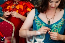 Wolds Way Farm, Yorkshire, England, showcases the intricate detail of the bride's gown as she and her daughter stand mirroring each other's actions during the wedding preparations.