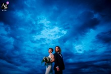 Old Town, Alexandria — During blue hour at the reception venue, the couple stand back to back and look in the same direction, framed low and center in a minimalist wedding portrait against the twilight sky.