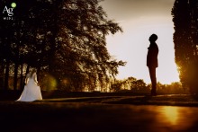 During a sunset photoshoot at huis de Voorst in Zuid Holland, the bride and groom stand outside, taking part in portraits while the daylight fades.