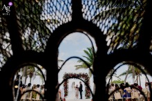   The ceremony setting at Blue Venado in Mexico features chairs arranged in the sand with palm trees and ocean beyond, offering a scenic and inviting backdrop for the wedding. 