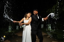   Bubbles and joy surround the couple at South Farm as they share a champagne spray portrait, the rural backdrop adding a playful spirit to the scene.
