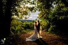   Set within the natural surroundings of Château de Frétoy in Bourgogne-Franche-Comté, the bride and groom stand together under the veil, their portrait blending nature and romance.