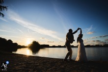 Couple Dances Barefoot On Sand At Sunset In Romantic Beach Portrait As the sun sets, the couple dances barefoot on the sand, the golden light and tranquil beach creating a romantic scene that celebrates their union.