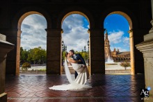   Against the ornate backdrop of Plaza de España in Sevilla, Spain, María and Mere are depicted in a composed portrait, the architectural beauty framing their wedding day elegance.