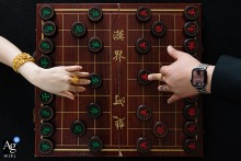 At a hotel in China, guests enjoy a game of traditional Chinese chess, creating a thoughtful wedding-day scene that reflects quiet strategy, culture, and moments of calm between the celebrations.