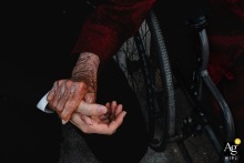 At the ceremony venue in Zhanjiang, Guangdong, China, the groom pauses to chat with his grandmother before leaving for the ceremony, as she gently holds his hand a little longer, creating a touching moment of love and reluctant farewell.