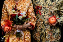 On the walk home in Zhanjiang, Guangdong, China, a detail photograph captures the newlyweds holding an apple as they follow a traditional Chinese wedding custom while making their way from the bride’s home to the groom’s home.