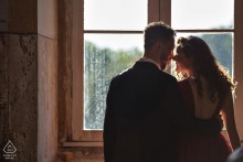 São Jose das Três Ilhas couple e-session in Minas Gerais while touching noses indoors by the window light
