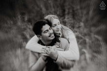 At Rob Wallace Park in Midland, NC, a couple shares a dreamy, romantic embrace in a field, surrounded by the serene beauty of nature.