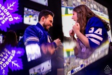 Celebrating Love and Hockey: Engaged Couple Cheering for Maple Leafs at Maple Leaf Square A couple enthusiastically watches a Maple Leafs game at Maple Leaf Square, surrounded by fellow fans and excitement.