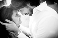 Couple embraces lovingly during their engagement session in Chicago’s vibrant and bustling Fulton Market district.