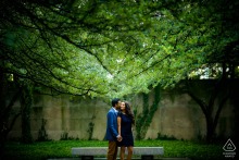 Couple embraces underneath lush tree canopy during their engagement session at Chicago’s Art Institute South Garden.