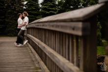 Couple quietly pauses on Brewster Gardens bridge, Plymouth, Massachusetts; framed by gentle tension.