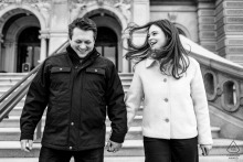 Engaged couple in Washington DC, walking down Library of Congress steps, sharing a romantic joyful portrait.