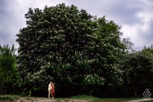 Rockanje Beach Pre-Wedding Shoot: Couple Poses Before Approaching Rainstorm Engaged couple poses at Rockanje beach, Netherlands, during pre-wedding shoot before approaching rainstorm.