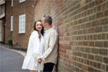 Hertfordshire, England - Groom to be kisses bride to be, surrounded by historic St Albans houses.