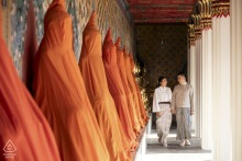 Engaged Couple Walks Through Temple Corridors In Bangkok For Romantic Engagement Portrait Engagement portrait of a couple walking in the corridors of a temple in Bangkok, Thailand.