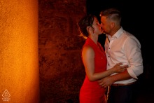 RECLESNE, France — A couple stands in a romantic nighttime setting, their connection glowing brightly in this engagement portrait. The image captures their affection.