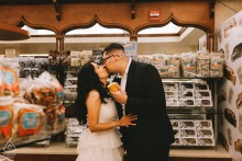 Downtown Annapolis, Maryland — A couple shares a kiss inside an ice cream shop, adding sweet charm to their engagement portrait in this lively downtown location.