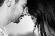 This tight black and white portrait from a private atelier in Ravenna, Italy, captures an intimate detail during a love session, showing the couple standing close, lovingly head to head.