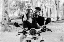 In Toulouse, France, the couple sits together on a scooter, center-framed in a black-and-white portrait just before starting their ride.