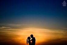 In Perez, Santa Fe, Argentina, an engaged couple poses face to face in silhouette during a golden hour sunset portrait session.