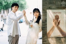 Sanlihe Engagement Portrait: Couple High-Fiving Before Wall, Mirroring Nearby Photo At Sanlihe in Beijing, China, a couple poses for a portrait as they high-five in front of a wall, mirroring a photograph displayed nearby.