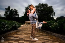 In Philadelphia, a man lifts his fiancée into the air for a portrait, her smile illuminated by the photographer’s skillful on-location lighting.