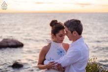 With the ocean stretching behind them at The Knob in Falmouth, MA, the couple shares a gentle embrace in fading daylight, blending natural light and emotional depth in a truly evocative portrait.