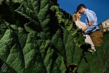 A couple shares a close embrace during an engagement portrait session set against an urban backdrop in San Francisco, California.