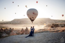 The couple shares an adventurous engagement session in the unique landscape of Cappadocia, Turkiye, surrounded by the iconic rock formations and breathtaking natural beauty of this historic region.