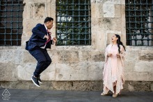 A Laughing, Playful Couple Jumps On Eminönü’s Streets In Istanbul, Surrounded By City’s Historic Richness A couple walks, laughs, and jumps through the streets of Eminönü in Istanbul, Turkey, their pre-wedding session framed by the bustling city atmosphere and the rich historical backdrop of one of Istanbul’s oldest neighborhoods.