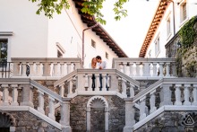 A couple hugs on a grand staircase at Stanjel Castle in Slovenia, their engagement portrait framed by beautiful stone steps and old-world architectural details that add a romantic, timeless atmosphere.