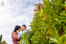 A pre-wedding portrait at Fortaleza de la Mota in Alcalá la Real, Jaén, Spain, captured against the foliage at the fortress, highlighting their connection in soft light.