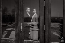 Standing in the doorway of a chalet, an engaged couple at Kondiaronk Belvedere in Montreal, Quebec, Canada, admires the stunning city view.